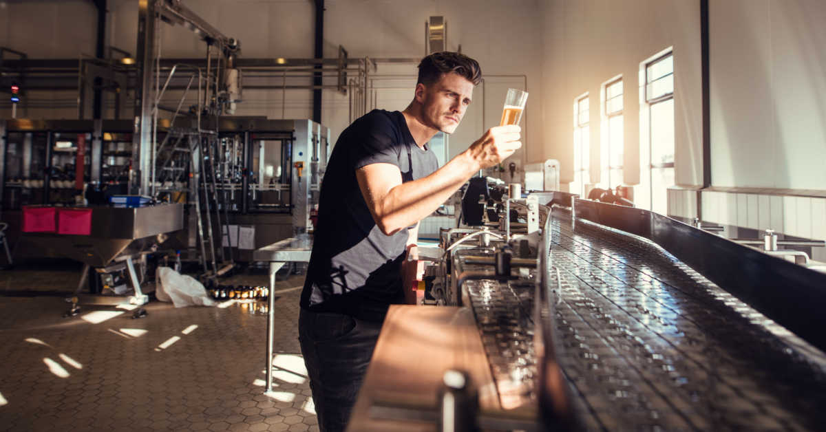 micro brewery owner examining the quality of craft beer