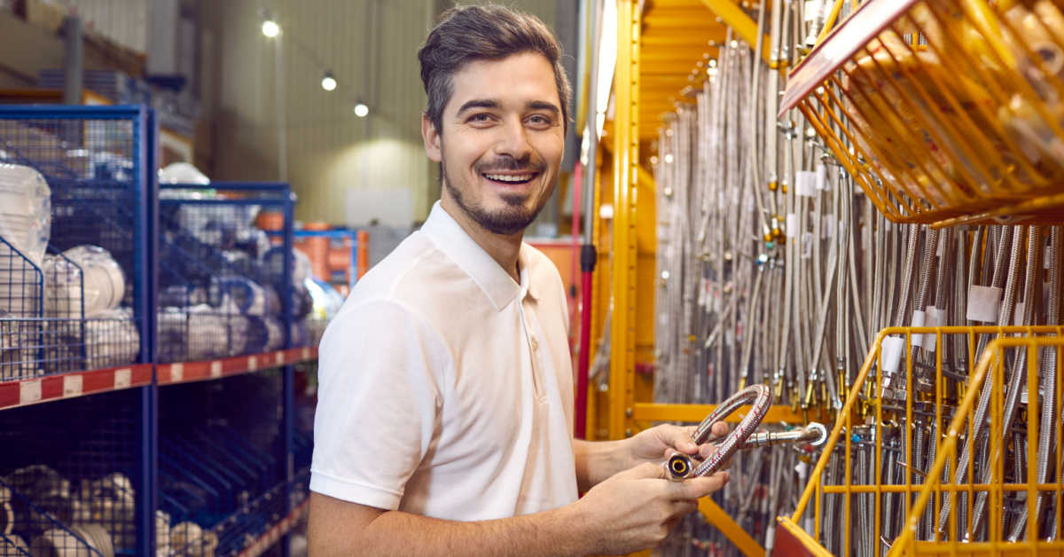 tradie buying materials at hardware store portrait of a happy man standing in the aisle